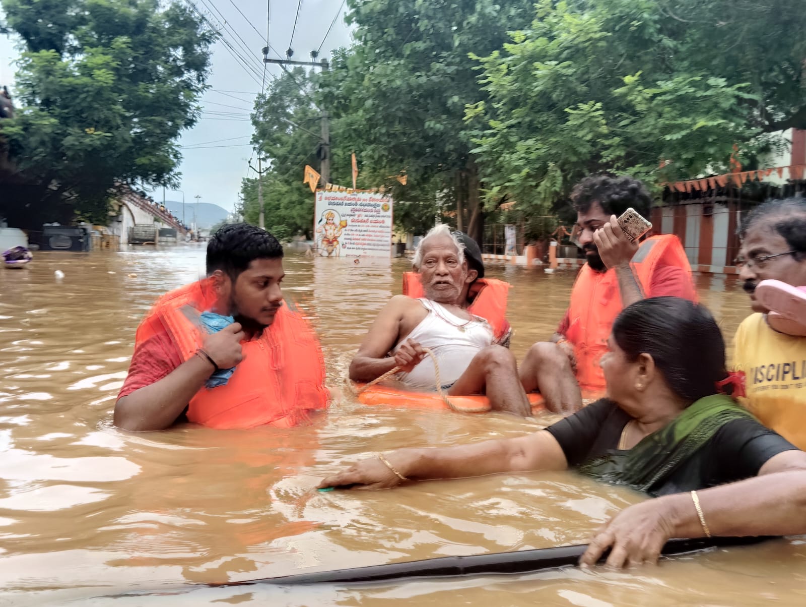 DISTRIBUTION OF FOOD AND HELPING FLOOD VICTIMS IN VIJAYAWADA